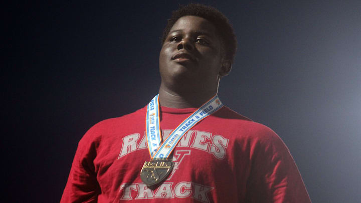 Raines sophomore Solomon Thomas stands atop the podium with his boys discus gold medal at the FHSAA