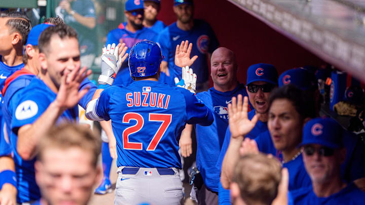 Mar 30, 2025; Phoenix, Arizona, USA; Chicago Cubs outfielder Seiya Suzuki (27) celebrates with his team in the dugout after hitting a home run in the top of the sixth inning against the Arizona Diamondbacks at Chase Field.