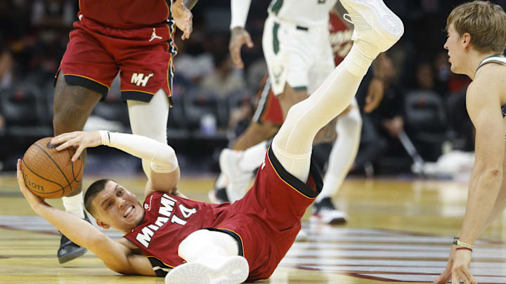 Nov 26, 2025; Miami, Florida, USA; Miami Heat guard Tyler Herro (14) grabs a loose ball against the Milwaukee Bucks during the second half of an NBA Cup game at Kaseya Center. Mandatory Credit: Rhona Wise-Imagn Images