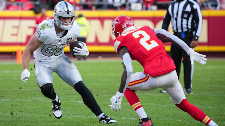 Nov 29, 2024; Kansas City, Missouri, USA; Las Vegas Raiders tight end Brock Bowers (89) runs the ball as Kansas City Chiefs cornerback Joshua Williams (2) defends during the first half at GEHA Field at Arrowhead Stadium. Mandatory Credit: Denny Medley-Imagn Images