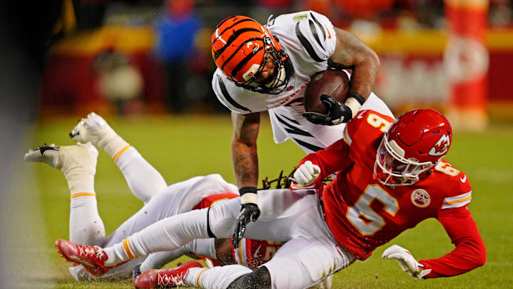 Jan 29, 2023; Kansas City, Missouri, USA; Cincinnati Bengals running back Samaje Perine (34) falls over Kansas City Chiefs safety Bryan Cook (6) during the second quarter of the AFC Championship game at GEHA Field at Arrowhead Stadium. Mandatory Credit: Jay Biggerstaff-Imagn Images