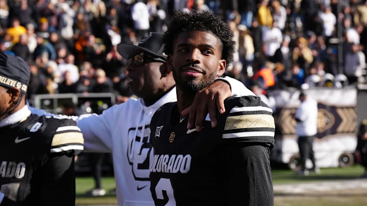 Nov 29, 2024; Boulder, Colorado, USA; Colorado Buffaloes quarterback Shedeur Sanders (2) and head coach Deion Sanders ifollowing the win over the Oklahoma State Cowboys at Folsom Field. Mandatory Credit: Ron Chenoy-Imagn Images