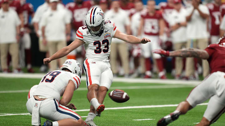 Dec 28, 2023; San Antonio, TX, USA; Aizona Wildcats place kicker Tyler Loop (33) kicks a 37-yard field goal out of the hold of punter Kyle Ostendorp (19) in the second half of the Alamo Bowl against the Oklahoma Sooners at Alamodome. Dec 28, 2023; San Antonio, TX, USA; Aizona Wildcats place kicker Tyler Loop (33) kicks a 37-yard field goal out of the hold of punter Kyle Ostendorp (19) in the second half of the Alamo Bowl against the Oklahoma Sooners at Alamodome.