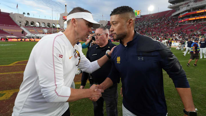 Nov 30, 2024; Los Angeles, California, USA; Southern California Trojans head coach Lincoln Riley and Notre Dame Fighting Irish head coach Marcus Freeman shake hands after the game at United Airlines Field at Los Angeles Memorial Coliseum. 