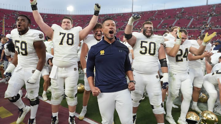 Nov 30, 2024; Los Angeles, California, USA; Notre Dame Fighting Irish head coach Marcus Freeman celebrates with players at the end of the game against the Southern California Trojans at United Airlines Field at Los Angeles Memorial Coliseum. Mandatory Credit: Kirby Lee-Imagn Images