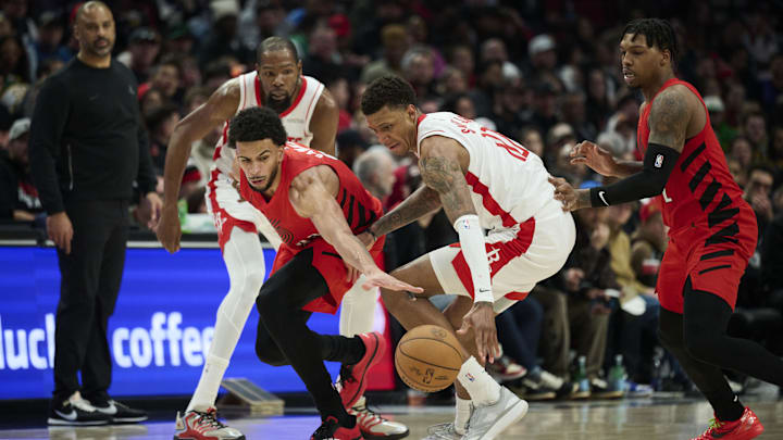 Jan 9, 2026; Portland, Oregon, USA; Portland Trail Blazers forward Toumani Camara (33) attempts to steal the ball during the second half against Houston Rockets forward Jabari Smith Jr. (10) at Moda Center. Mandatory Credit: Troy Wayrynen-Imagn Images