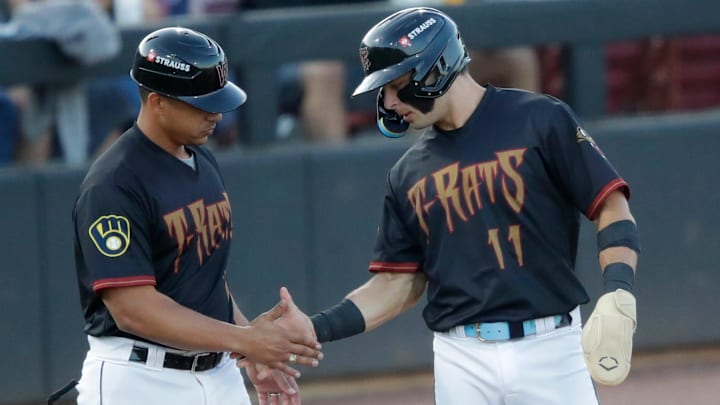 Wisconsin Timber Rattlers' manager Victor Estevez (7) congratulates Andrew Fischer (11) getting to third base during their baseball game against the Quad Cities River Bandits Wednesday, August 27, 2025, at Neuroscience Group Field at Fox Cities Stadium in Grand Chute, Wisconsin. Quad City won 9-5.