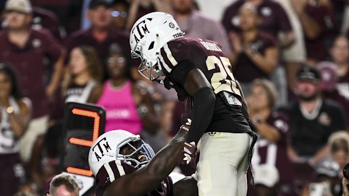 Oct 11, 2025; College Station, Texas, USA; Texas A&M Aggies defensive tackle Albert Regis (17) hoists safety Dalton Brooks (25) after he recovered a fumble in the third quarter against the Florida Gators at Kyle Field. Mandatory Credit: Maria Lysaker-Imagn Images 