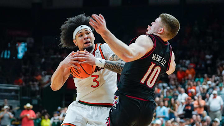 Mar 7, 2026; Coral Gables, Florida, USA; Miami Hurricanes guard Tre Donaldson (3) drives to the basket against Louisville Cardinals guard Isaac McKneely (10) during the second half at Watsco Center. Mandatory Credit: Jeff Romance-Imagn Images