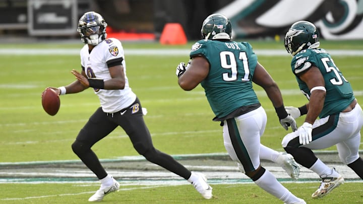 Oct 18, 2020; Philadelphia, Pennsylvania, USA; Baltimore Ravens quarterback Lamar Jackson (8) rolls out of the pocket against Philadelphia Eagles defensive tackle Fletcher Cox (91) and defensive end Brandon Graham (55) during the fourth quarter at Lincoln Financial Field. Mandatory Credit: Eric Hartline-Imagn Images