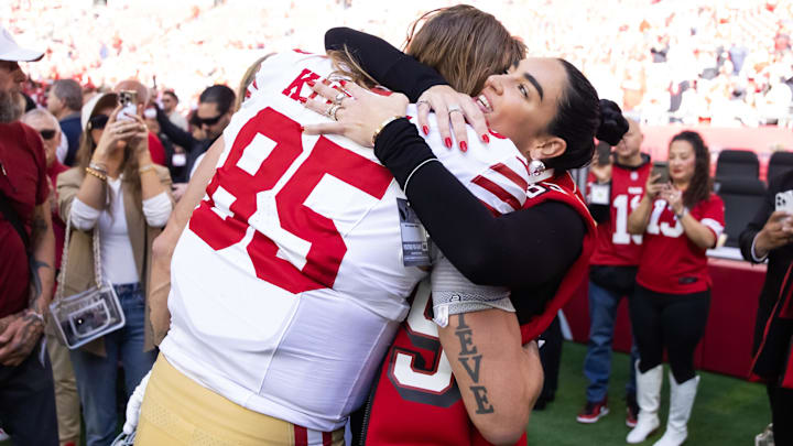 Jan 5, 2025; Glendale, Arizona, USA; San Francisco 49ers tight end George Kittle (85) hugs wife Claire Kittle prior to the game against the Arizona Cardinals at State Farm Stadium.
