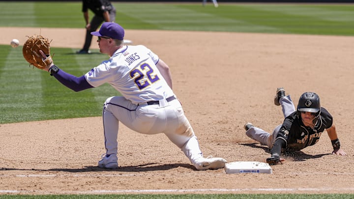 May 31, 2024; Chapel Hill, NC, USA; LSU first baseman Jared Jones (22) tries to catch Wofford infielder Brice Martinez (10) during the NCAA Regional in Chapel Hill. Mandatory Credit: Jim Dedmon-Imagn Images May 31, 2024; Chapel Hill, NC, USA; LSU first baseman Jared Jones (22) tries to catch Wofford infielder Brice Martinez (10) during the NCAA Regional in Chapel Hill. Mandatory Credit: Jim Dedmon-Imagn Images