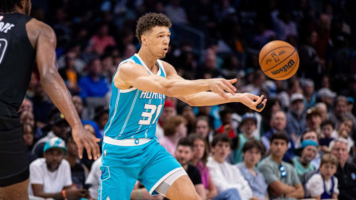 Mar 8, 2025; Charlotte, North Carolina, USA; Charlotte Hornets forward Tidjane Salaun (31) passes the ball away during the fourth quarter against the Brooklyn Nets at Spectrum Center. Mandatory Credit: Scott Kinser-Imagn Images