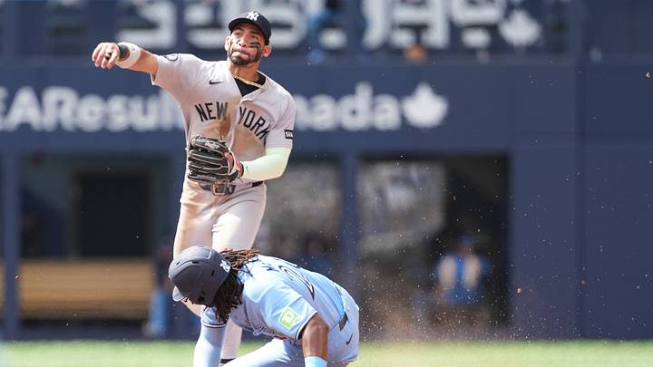 Aug 16, 2026; Toronto, Ontario, CAN; Toronto Blue Jays first baseman Charles McAdoo (26) is tagged out at second base by New York Yankees shortstop José Caballero (72) during the sixth inning at Rogers Centre. Mandatory Credit: Nick Turchiaro-Imagn Images