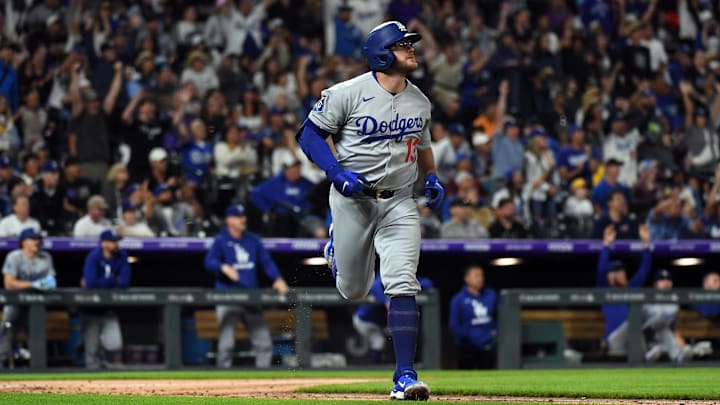 Denver, Colorado, USA; Los Angeles Dodgers third base Max Muncy (13) hits a grand slam during the seventh inning against the Colorado Rockies at Coors Field.