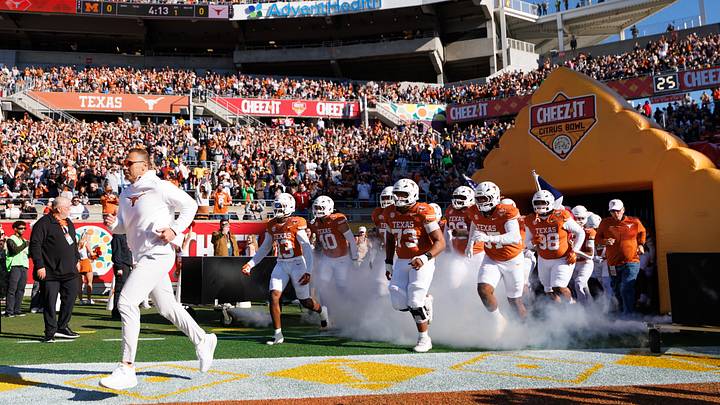 Texas Longhorns head coach Steve Sarkisian, Texas Longhorns wide receiver Parker Livingstone (13) and offensive lineman Brandon Baker (73) run onto the field before a game against the Michigan Wolverines. Texas Longhorns head coach Steve Sarkisian, Texas Longhorns wide receiver Parker Livingstone (13) and offensive lineman Brandon Baker (73) run onto the field before a game against the Michigan Wolverines.