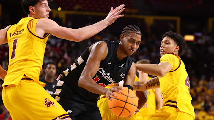 Jan 24, 2026; Tempe, Arizona, USA; Cincinnati Bearcats forward Baba Miller (18) drives to the basket against Arizona State Sun Devils forward Santiago Trouet (1) and guard Bryce Ford (4) in the first half at Desert Financial Arena. Mandatory Credit: Mark J. Rebilas-Imagn Images Jan 24, 2026; Tempe, Arizona, USA; Cincinnati Bearcats forward Baba Miller (18) drives to the basket against Arizona State Sun Devils forward Santiago Trouet (1) and guard Bryce Ford (4) in the first half at Desert Financial Arena. Mandatory Credit: Mark J. Rebilas-Imagn Images