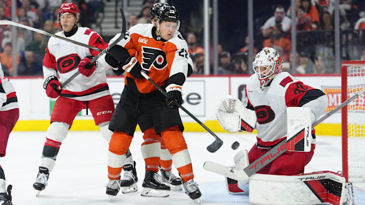 Apr 13, 2026; Philadelphia, Pennsylvania, USA; Philadelphia Flyers center Christian Dvorak (22) attempts to deflect a shot against Carolina Hurricanes goalie Brandon Bussi (32) in the third period at Xfinity Mobile Arena. Mandatory Credit: Kyle Ross-Imagn Images