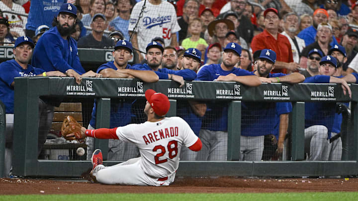 Jul 12, 2022; St. Louis, Missouri, USA;  St. Louis Cardinals third baseman Nolan Arenado (28) slides but is unable to catch a foul ball hit by Los Angeles Dodgers center fielder Cody Bellinger (not pictured) during the seventh inning at Busch Stadium. Mandatory Credit: Jeff Curry-Imagn Images