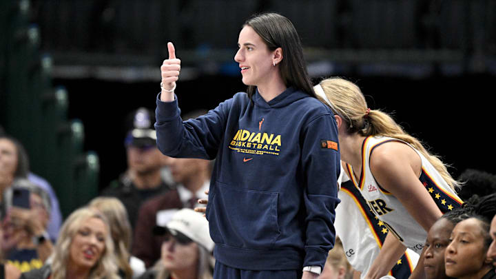 Aug 1, 2025; Dallas, Texas, USA;  Indiana Fever guard Caitlin Clark (22) gives a thumbs up during the first half against the Dallas Wings at the American Airlines Center. Mandatory Credit: Jerome Miron-Imagn Images