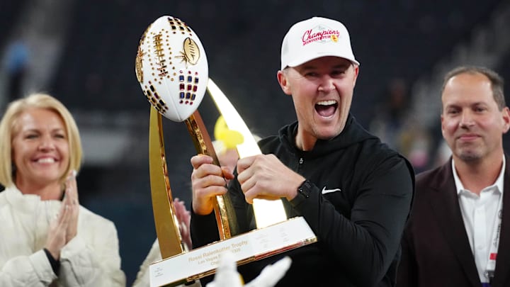 Dec 27, 2024; Las Vegas, NV, USA; Southern California Trojans head coach Lincoln Riley holds the championship trophy after the game against the Texas A&M Aggies at Allegiant Stadium. Mandatory Credit: Kirby Lee-Imagn Images