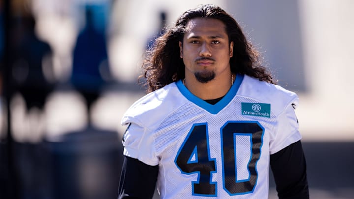 Carolina Panthers linebacker Tuasivi Nomura walks to the field for training camp.