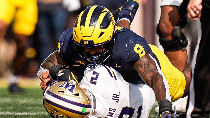 Michigan edge Derrick Moore (8). Michigan edge Derrick Moore (8).