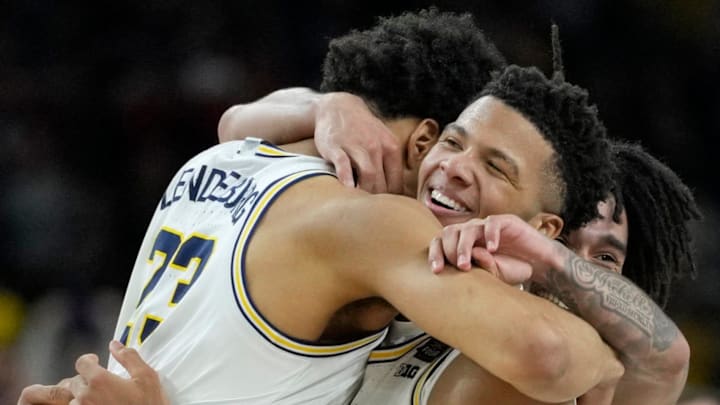 Michigan Wolverines forward Yaxel Lendeborg (23) and Wolverines guard Trey McKenney (1) celebrate their NCAA men's basketball tournament national championship victory Monday, April 6, 2026, after defeating the UConn Huskies 69-63 at Lucas Oil Stadium in Indianapolis.