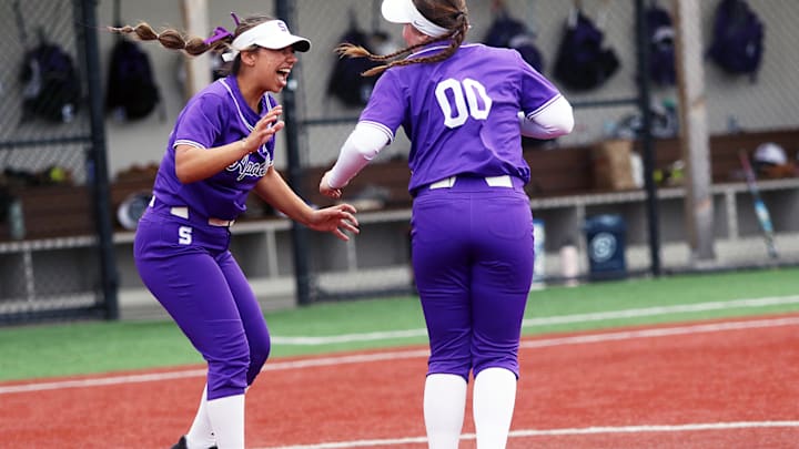 Sunset senior Dajah Paz (left) and freshman Sydney Arnold celebrate after the Apollos’ 3-2 eight-inning win over McNary.