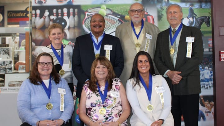 Representatives from the Greater Syracuse Sports of Hall of Fame recently announced its Class of 2025 inductees, which includes a handful of former high school standouts. In the front row, from left, are Chris Lindsey, Kim Sharpe Green and Brittany Brigandi. In the back row, from left, are Buddy Hardeman, Bill Sanford and Frank Riccelli.