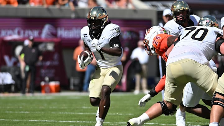 Oct 4, 2025; Blacksburg, Virginia, USA;  Wake Forest Demon Deacons running back Demond Claiborne (1) runs the ball during the first quarter against the Virginia Tech Hokies at Lane Stadium. Mandatory Credit: Brian Bishop-Imagn Images