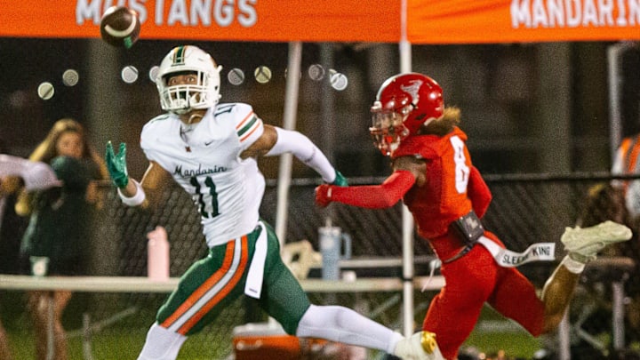 Mandarin Mustangs wide receiver Brysen Wright (11) tries to pull in a pass as a Bradford Tyler Berry (8) grabs his arm. The Bradford Tornadoes hosted the Mandarin Mustangs at David Hurse Stadium at Bradford High School in Starke, FL on Friday, September 13, 2024. The Mustangs lead 13-6 at the beginning of the fourth quarter.[Doug Engle/Ocala Star Banner]