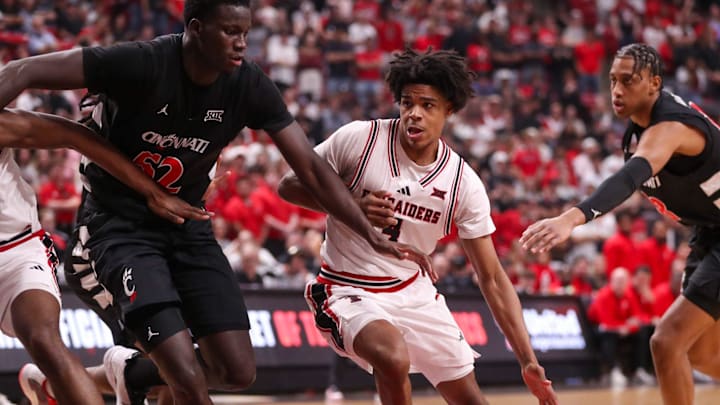 Texas Tech's Christian Anderson dribbles against Cincinnati defender Moustapha Thiam during a Big 12 Conference men's basketball game, Tuesday, Feb. 24, 2026, in United Supermarkets Arena.