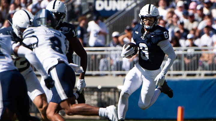 Penn State's Trebor Pena runs with the ball in the first half of an NCAA football game against Nevada.