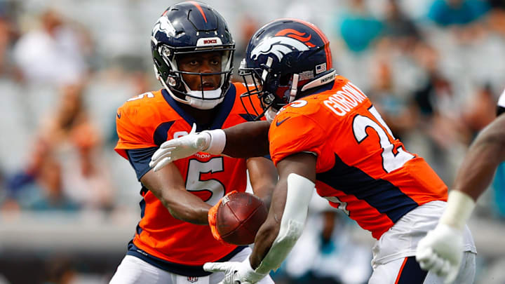 Sep 19, 2021; Jacksonville, Florida, USA;  Denver Broncos quarterback Teddy Bridgewater (5) hands off to running back Melvin Gordon (25) in the fourth quarter at TIAA Bank Field. 