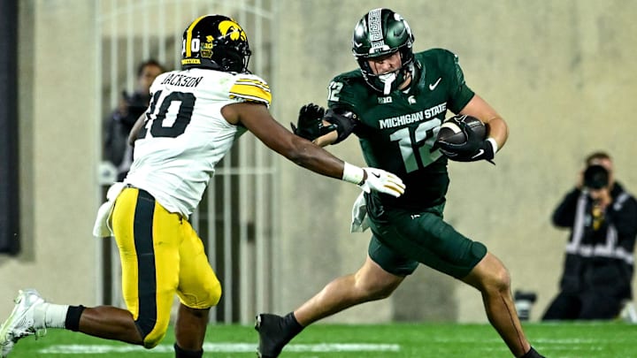 Michigan State's Jack Velling, right, runs after a catch as Iowa's Nick Jackson closes in during the third quarter on Saturday, Oct. 19, 2024, at Spartan Stadium in East Lansing.