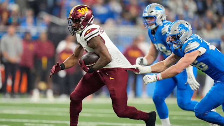 Detroit Lions linebacker Jack Campbell (46) attempts to stop Washington Commanders running back Brian Robinson Jr. (8) as he runs the ball in the first quarter in the NFC divisional round at Ford Field in Detroit on Saturday, Jan. 18, 2025.