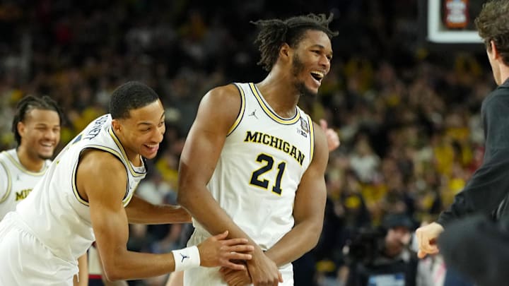 Apr 6, 2026; Indianapolis, IN, USA; Michigan Wolverines forward Morez Johnson Jr. (21) and guard Nimari Burnett (4) celebrate after their win against the UConn Huskies in the national championship of the Final Four of the men's 2026 NCAA Tournament between the  and the Michigan Wolverines at Lucas Oil Stadium. Mandatory Credit: Bob Donnan-Imagn Images