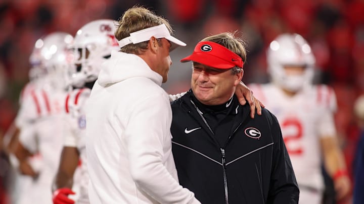 Nov 11, 2023; Athens, Georgia, USA; Mississippi Rebels head coach Lane Kiffin talks to Georgia Bulldogs head coach Kirby Smart before a game at Sanford Stadium. Mandatory Credit: Brett Davis-Imagn Images