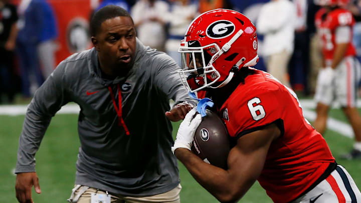 Georgia running back Kenny McIntosh (6) runs a drill with Georgia Wide Receivers Coach Bryan McClendon before the start of the SEC Championship NCAA college football game between LSU and Georgia in Atlanta, on Saturday, Dec. 3, 2022.

News Joshua L Jones