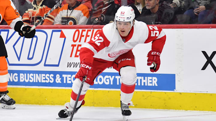 Detroit Red Wings right wing Jonatan Berggren (52) reaches for the puck in a match-up with the Flyers.