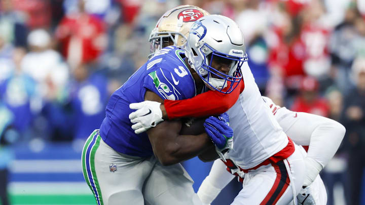 Oct 10, 2024; Seattle, Washington, USA; San Francisco 49ers cornerback Deommodore Lenoir (2) tackles Seattle Seahawks running back Kenneth Walker III (9) during the first quarter at Lumen Field. Mandatory Credit: Joe Nicholson-Imagn Images Oct 10, 2024; Seattle, Washington, USA; San Francisco 49ers cornerback Deommodore Lenoir (2) tackles Seattle Seahawks running back Kenneth Walker III (9) during the first quarter at Lumen Field. Mandatory Credit: Joe Nicholson-Imagn Images