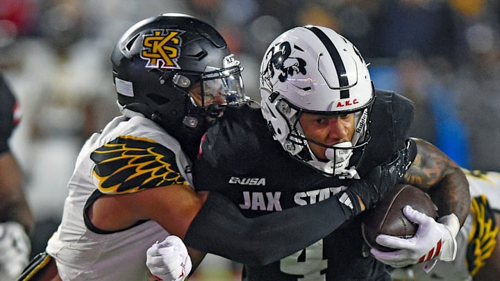 Jax State's Cam Cook tries to evade the tackle of Kennesaw State's Alexander Ford during the C-USA Championship at AmFirst Stadium in Jacksonville, Alabama December 5, 2025. (Dave Hyatt / Hyatt Media LLC)