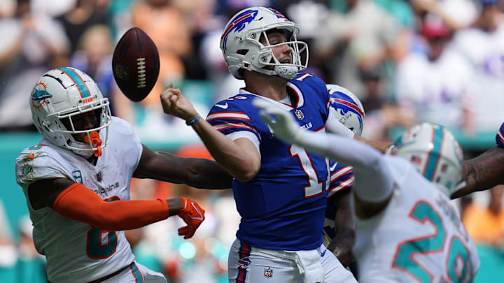 Buffalo Bills quarterback Josh Allen (17) fumbles after getting hit by Jevon Holland (8) of the Miami Dolphins during the first quarter of an NFL game at Hard Rock Stadium in Miami Gardens, Sept. 25, 2022.