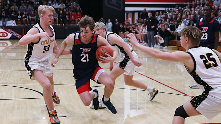 Ballard guard Jackson Brown (21) drives to the basket between Clear Lake forward Max Larson (53) and guard Titan Schmitt (25) during the third quarter in the class 3A boys sub-state final on Monday, Feb. 26, 2024, in Clarion, Iowa.