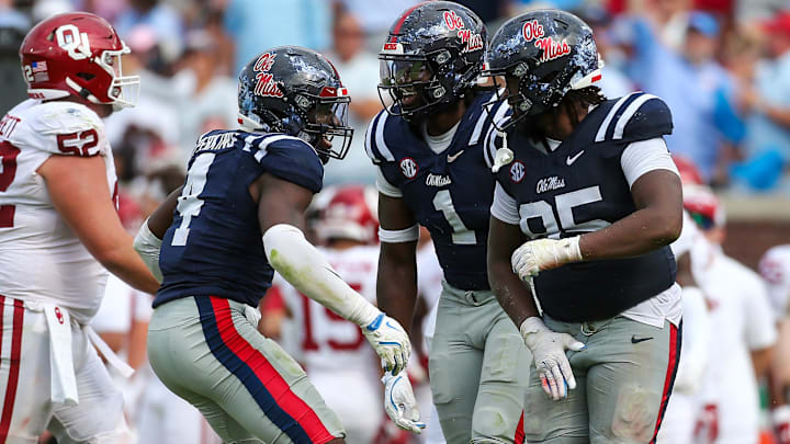 Oct 26, 2024; Oxford, Mississippi, USA; Mississippi Rebels linebacker Suntarine Perkins (4), defensive lineman Princely Umanmielen (1) and defensive lineman Akelo Stone (95) reacts after a sack during the second half  against the Oklahoma Sooners at Vaught-Hemingway Stadium. Mandatory Credit: Petre Thomas-Imagn Images