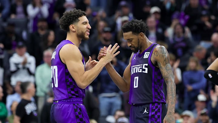Dec 3, 2024; Sacramento, California, USA; Sacramento Kings guard Malik Monk (0) is congratulated by guard Colby Jones (20) during the fourth quarter against the Houston Rockets at Golden 1 Center. Mandatory Credit: Sergio Estrada-Imagn Images