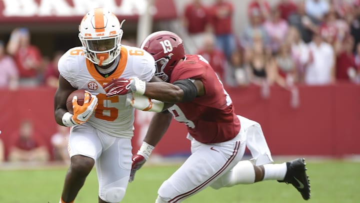 Oct 24, 2015; Tuscaloosa, AL, USA; Tennessee Volunteers running back Alvin Kamara (6) carries the ball against Alabama Crimson Tide linebacker Reggie Ragland (19) during the first quarter at Bryant-Denny Stadium. Mandatory Credit: John David Mercer-Imagn Images