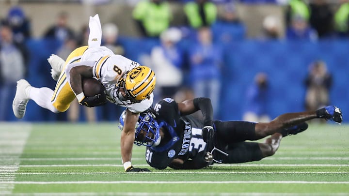 Missouri Tigers running back Nathaniel Peat runs for a gain as Kentucky Wildcats defensive back Maxwell Hairston (31) makes the tackle in the second quarter on Oct. 14, 2023. Missouri Tigers running back Nathaniel Peat runs for a gain as Kentucky Wildcats defensive back Maxwell Hairston (31) makes the tackle in the second quarter on Oct. 14, 2023.