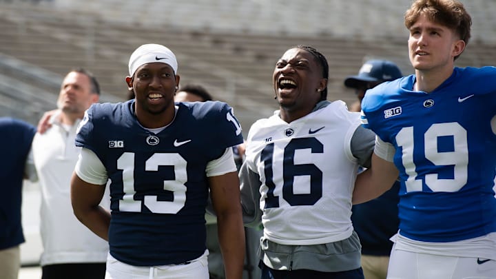 Penn State's King Mack (16) sings the alma mater with teammates Kaytron Allen (13) and Jack Lambert (19) during the 2025 Blue-White Game at Beaver Stadium. 
